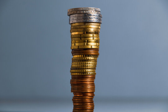 A Tall Stack Of Coins. Euro Coins Are Piled Up, The Largest Coins Are On Top Of The Smaller Ones