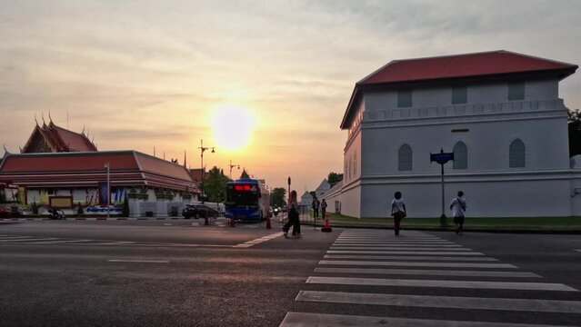 Time lapse shots of  Wat Pa Kew with cars on street road and People on crosswalk.