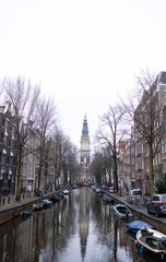 Fototapeta premium Groenburgwal Canal in Amsterdam. There is beautiful Zuiderkerk tower in the background.