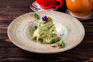 French dessert cake Napoleon or Millefeuille from puff pastry with custard pistachio cream.