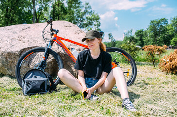 Young attractive woman is resting after bicycle ride. Active lifestyle, sports