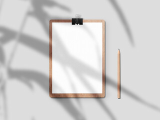 Wooden writing pad mockup. Clipboard with blank a4 paper and pencil with shadow overlay. Minimal business branding display concept.
