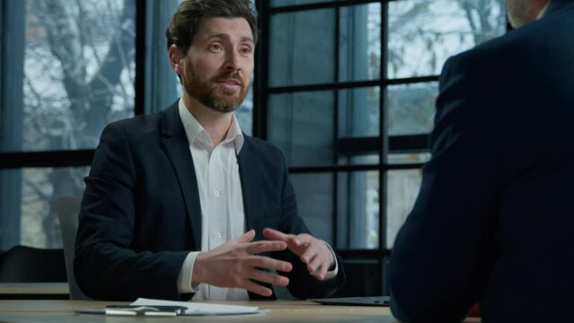 Businessman professional manager insurer consulting client about insurance benefits confident man leader sitting in office talking to business partner customer service manager salesman advises buyer