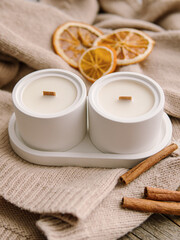Two coconut wax candles in concrete cups. Scented candles for interior. Candles with the aroma of mulled wine. Natural