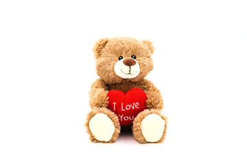 Teddy bear with red heart and text 'I love you' isolated on white background. Concept Valentine's...