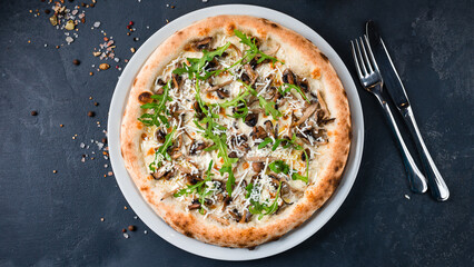 Italian pizza with mushrooms, goat cheese, parmesan, arugula and spices.