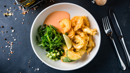 Fritto misto crispy shrimp with zucchini, cucumbers, arugula and sauce.