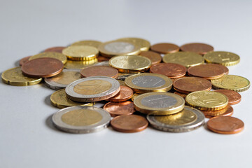 Spilled euro coins on a gray table. Soft focus