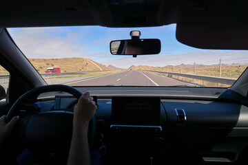 Driver driving a car on asphalt road.