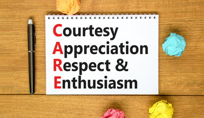 CARE symbol. Concept words CARE courtesy appreciation respect and enthusiasm on white note on beautiful wooden background. Business CARE courtesy appreciation respect enthusiasm concept. Copy space.