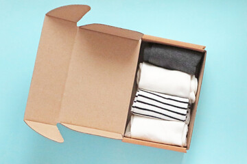 Craft Cardboard Box Container with socks on the blue background