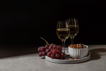 Champagne glasses, grapes and nuts on the table