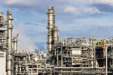 Industrial refinery complex with lots of pipes and smokestacks