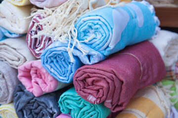 Multicolored Turkish bath towels, traditional hammam towels made from natural cotton, rolled in a roll at a street market in Bodrum
