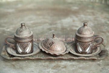 traditional turkish embossed metal coffee cup with tray close-up selective focus