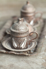 traditional turkish embossed metal coffee cup with tray close-up selective focus