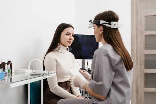 ENT Doctor Explain Patient Causes Of Difficulty Breathing. Consultation Of Woman With Otolaryngologist In A Medical Clinic.