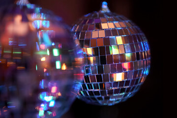 Abstract bright festive background. Two disco balls on a black background. Defocused mirrored disco...