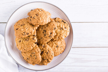 Homemade oatmeal raisin cookies  on a plate. Healthy baking. Top view. Copy space