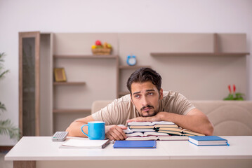 Young male student studying at home during pandemic