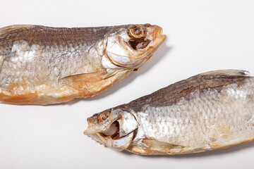 two dried fish vobla  heads isolated on white background, close up