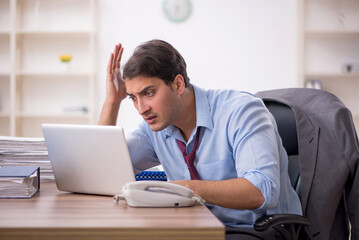 Young male employee working in the office