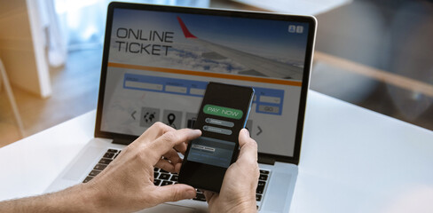 Man search and pay tickets vacation on laptop. Booking flight. Plan travel and book holidays online