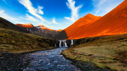 Landscape of Iceland with a small stream and a waterfall