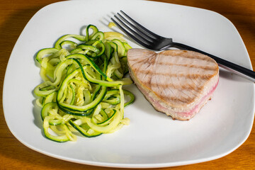 tuna steak served with a side of zucchini noodles