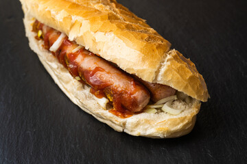 Bosna or Bosner, a spicy Austrian Hot Dog style Fast Food Dish with a Bratworst, Onions, Ketchup...