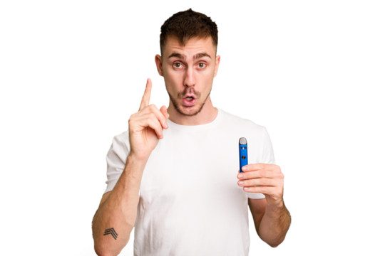 Young caucasian man holding a vaporizer cut out isolated having an idea, inspiration concept.