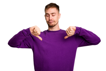 Young caucasian man cut out isolated showing thumb down, disappointment concept.