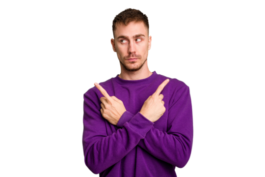 Young caucasian man cut out isolated points sideways, is trying to choose between two options.