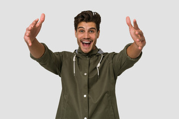 Fototapeta premium Young handsome caucasian man isolated on white background celebrating a victory or success, he is surprised and shocked.