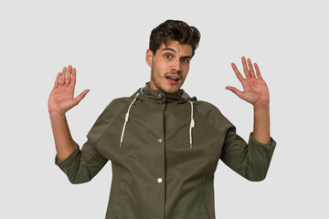 Young handsome caucasian man isolated on white background being shocked due to an imminent danger
