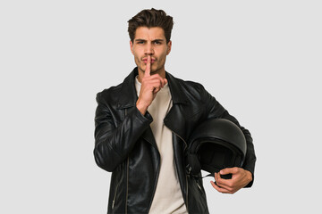 Young caucasian man holding a helmet isolated