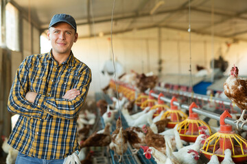 Portrait of a male farmer in a poultry farm - obrazy, fototapety, plakaty