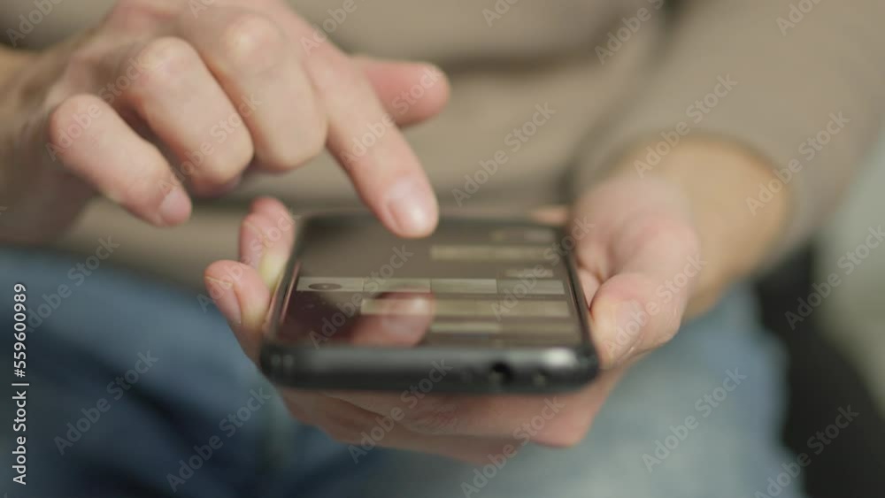 Aufkleber a man's finger touches a monitor to scroll a page on a mobile phone. viewing photos and documents in