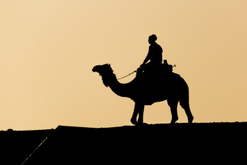 Silhouette of a camel rider at the Djoser (Zoser) funerary complex in Saqqara, Egypt