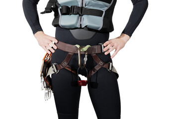 Man wearing climbing gear a black full wetsuit and buoyancy aid with a harness, belay device atc...
