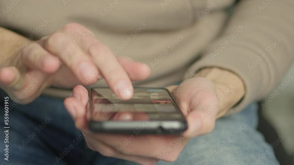 Poster A man's finger touches a monitor to scroll a page on a mobile phone. Viewing photos and documents in the smartphone library. A man in his hands uses a smartphone, turns pages.