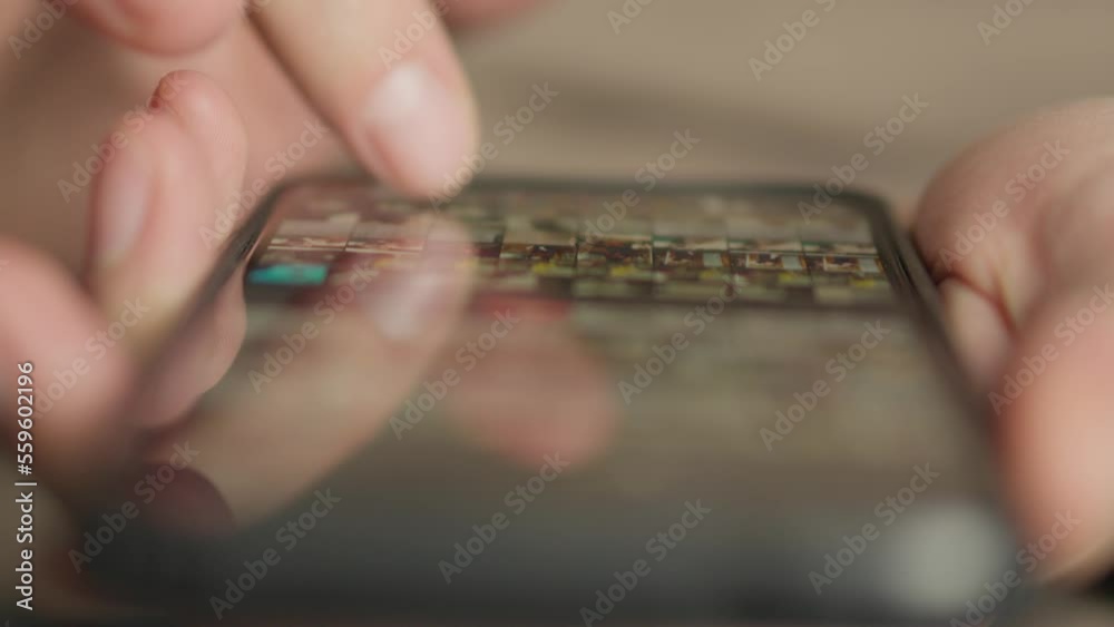 Aufkleber a man's finger touches a monitor to scroll a page on a mobile phone. viewing photos and documents in