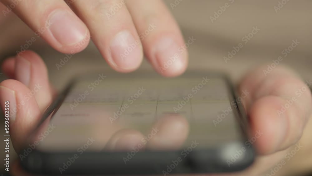 Poster A man's finger touches a monitor to scroll a page on a mobile phone. Viewing photos and documents in the smartphone library. A man in his hands uses a smartphone, turns pages.