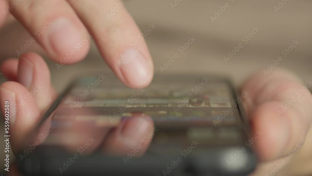 Poster A man's finger touches a monitor to scroll a page on a mobile phone. Viewing photos and documents in the smartphone library. A man in his hands uses a smartphone, turns pages.