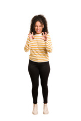 Fototapeta premium Young african american woman with curly hair cut out isolated showing claws imitating a cat, aggressive gesture.