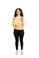 Young african american woman with curly hair cut out isolated celebrating a victory, passion and enthusiasm, happy expression.