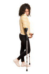 Fototapeta premium Full body young african american woman with crutches isolated
