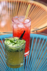 Glasses with fresh lemonade on the table. Strawberry Iced Lemonade and Kiwi Lemonade, cucumber and mint