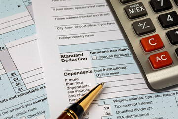 Standard deduction on federal income tax return forms and calculator. Federal tax return, income tax and tax refund concept
