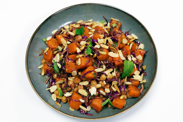 mediterranean style healthy pumpkin, chickpea and cabbage salad with almond flakes